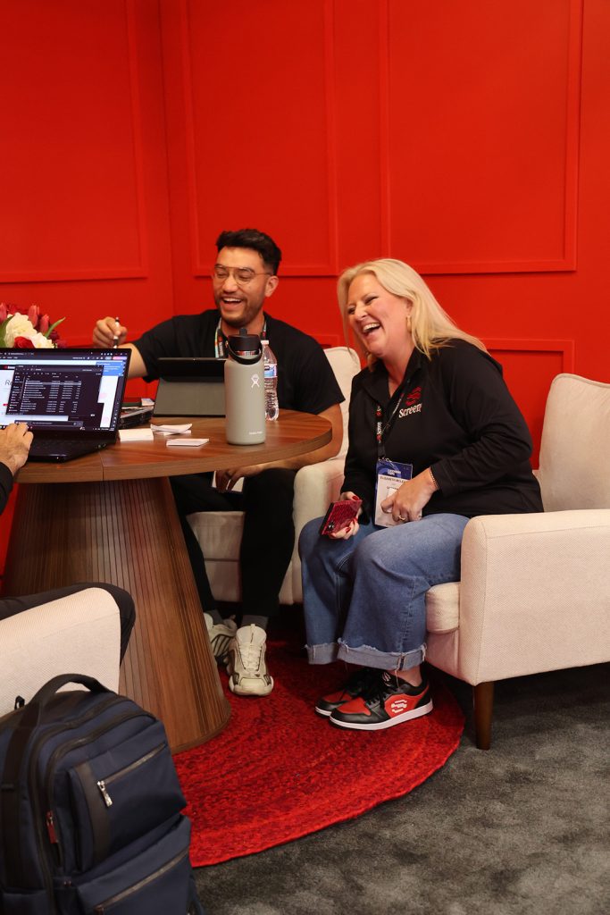 Screeny team in the red lounge at the Screeny booth at Licensing Expo