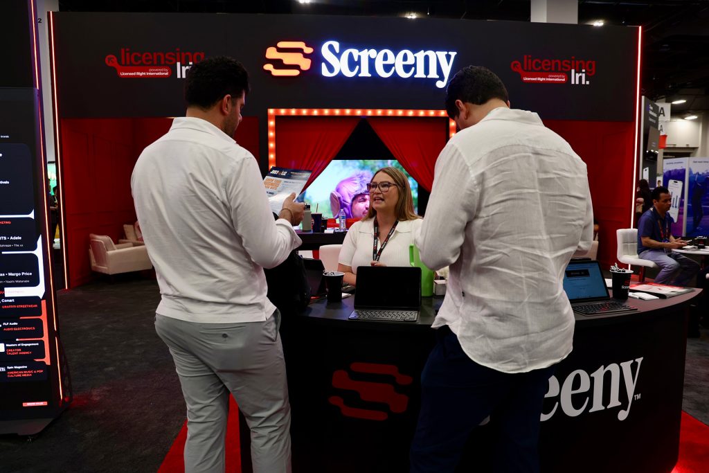 Screeny staff talking with visitors at the Screeny booth at Licensing Expo